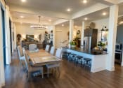 Thumbnail 23 of 35 - a kitchen and dining room with a table and chairs