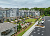 Thumbnail 17 of 31 - A large building with a parking lot in front of it.