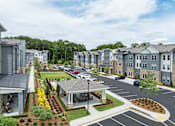Thumbnail 18 of 31 - A view of a residential area with houses and a parking lot.