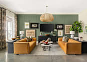 Thumbnail 13 of 31 - A living room with two yellow sofas and a coffee table.