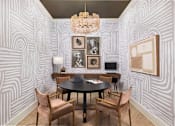 Thumbnail 14 of 31 - A room with a table and chairs and a wallpapered wall.