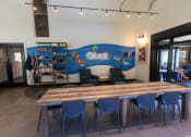 Thumbnail 10 of 66 - a large table with blue chairs and a mural on the wall