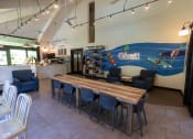 Thumbnail 8 of 66 - a dining area with a long wooden table with blue chairs and a large mural on the wall