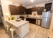 Thumbnail 9 of 40 - a kitchen with stainless steel appliances and a counter top