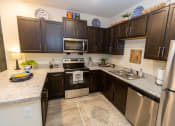 Thumbnail 8 of 40 - Walton Green family affordable community in Augusta, GA a kitchen with stainless steel appliances and granite counter tops