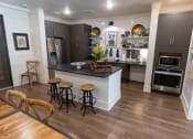 Thumbnail 8 of 40 - a kitchen with a large center island with a black countertop