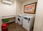 Thumbnail 16 of 40 - a laundry room with two washers and a dryer