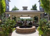 Thumbnail 34 of 40 - a gazebo with a fountain in the middle of a courtyard