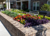 Thumbnail 4 of 40 - a flower bed in front of a building