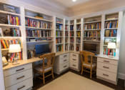 Thumbnail 15 of 40 - a home office with white cabinetry and a granite countertop
