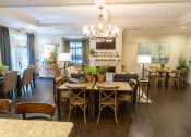 Thumbnail 9 of 40 - a dining room and living room with a chandelier