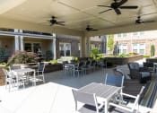Thumbnail 33 of 40 - an outdoor patio with tables and chairs