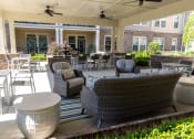 Thumbnail 23 of 40 - a patio with couches chairs and tables in front of a building