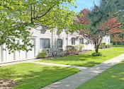 Thumbnail 22 of 37 - Lush green lawn area in front of apartment building at Brookwood at Ridge, New York