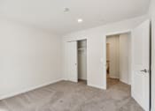 Thumbnail 19 of 37 - a bedroom with white walls and a door to a closet at Brookwood at Ridge, New York, 11961
