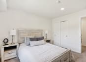 Thumbnail 3 of 37 - a spacious bedroom with a bed and a closet at Brookwood at Ridge, New York, 11961