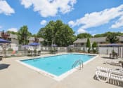 Thumbnail 6 of 37 - view of our sparkling swimming pool with chairs and umbrellas at Brookwood at Ridge, New York, 11961