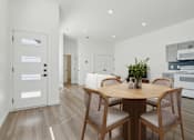 Thumbnail 2 of 48 - A modern dining room with a wooden table and chairs.