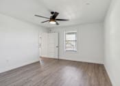 Thumbnail 9 of 48 - A room with a ceiling fan and a window with blinds.