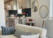 Thumbnail 44 of 48 - a living room with a couch and a kitchen