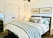 Thumbnail 41 of 48 - a bedroom with a bed with blue and white sheets and pillows