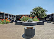 Thumbnail 6 of 38 - a courtyard with a fountain and plants in front of a building