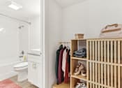 Thumbnail 16 of 38 - a bathroom with a crib and a toilet and a shower
