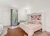 Thumbnail 1 of 38 - a bedroom with a bed and a dresser and a window