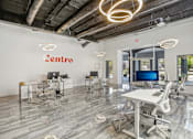 Thumbnail 7 of 38 - an open office space with desks and chairs and a tv
