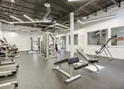 Thumbnail 10 of 38 - a gym with weights and other exercise equipment in a building