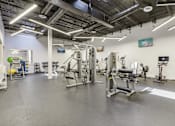 Thumbnail 37 of 38 - the gym at the community center with weights and exercise equipment