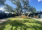 Thumbnail 45 of 48 - a yard with a tree in the middle of a building