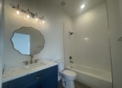 Thumbnail 15 of 48 - a bathroom with a sink and a toilet and a shower