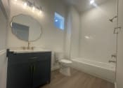 Thumbnail 20 of 48 - a bathroom with a sink and a toilet and a shower
