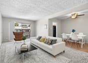 Thumbnail 1 of 17 - A living room with a white couch, a brown chair, and a glass table with a plant on it.