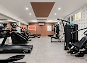 Thumbnail 13 of 60 - A gym with treadmills and exercise equipment.