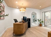 Thumbnail 44 of 60 - A modern office with a wooden desk and a black chair.