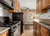 Thumbnail 3 of 18 - a kitchen with a stove top oven next to a sink