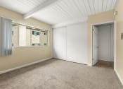Thumbnail 10 of 18 - a bedroom with beige walls and a white ceiling