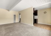 Thumbnail 8 of 18 - a living room with beige walls and a beige carpet