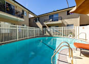 Thumbnail 22 of 23 - A swimming pool with a metal railing and a bench.