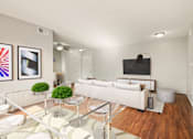 Thumbnail 5 of 47 - A modern living room with a glass coffee table and white furniture.