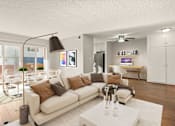 Thumbnail 1 of 47 - A modern living room with a white sofa and a glass table.