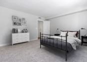 Thumbnail 10 of 38 - a bedroom with a bed and a dresser