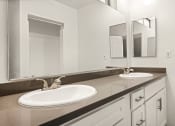 Thumbnail 19 of 38 - a bathroom with a sink and a mirror