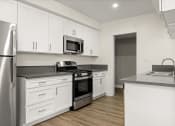 Thumbnail 14 of 38 - a kitchen with a stove top oven next to a refrigerator