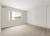 Thumbnail 20 of 38 - a bedroom with white walls and a window