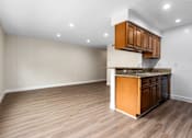 Thumbnail 46 of 69 - A kitchen with wooden cabinets and a countertop.