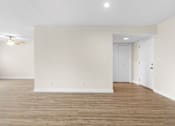 Thumbnail 53 of 69 - A room with wooden floors and white walls.