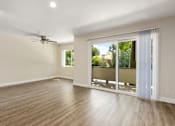 Thumbnail 23 of 69 - Living Room with Sliding Glass Doors at Lombardi Apartments, Woodland Hills, California